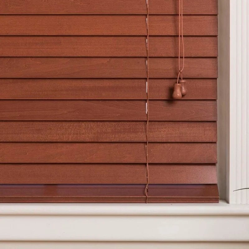 Wooden blinds in a home with white walls